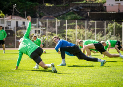 Football players warming up before training at the camp in Madeira